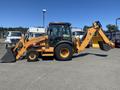 A 2016 Case 580 Super N backhoe loader with a yellow body and black attachments facing right