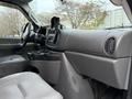 Interior view of a 2007 Ford E-350 showing the dashboard with controls and a cup holder in a light gray color