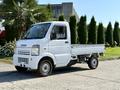 A white 2008 Suzuki Carry mini truck with a cargo bed and a compact cab design