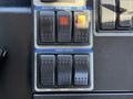Close-up of control panel with switches for beacon, auxiliary lights, PTO, and work lights on a 2012 Autocar XPERT