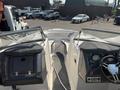 2013 Larson 238 boat interior featuring a dual console design with a steering wheel gauges and comfortable seating on either side