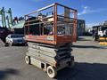 A 2010 Skyjack SJ aerial lift with a compact base and an open platform featuring safety railings and controls on the side