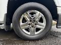 Close-up of a wheel from a 2011 Chevrolet Colorado featuring a shiny silver rim and a black tire with visible tread patterns