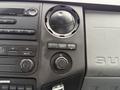 Dashboard controls of a 2011 Ford F-250 SD featuring knobs and buttons for air conditioning audio and power with a 12V outlet