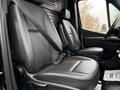 Interior of a 2022 Mercedes-Benz Sprinter showing two black leather seats with seatbelts in a modern cabin design