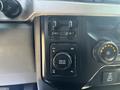 Control panel of a 2023 Ford F-350 SD with buttons for drive mode and terrain settings
