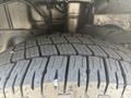 Close-up of a tire with deep tread patterns mounted on a 2017 Ford Transit-350 showcasing the tire's wear and grip features
