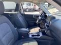 Interior of a 2023 Ford Bronco Sport showing front seats a steering wheel and a central console with controls and cup holders