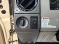Control panel of a 2009 Ford F-450 Super Duty featuring dials and switches for parking brake and other functions