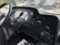 The interior dashboard of a 2018 Ford Econoline featuring various controls switches and gauges