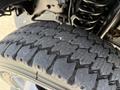 Close-up view of a worn tire with a rugged tread pattern on a 2015 Ford F-550