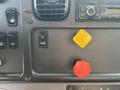 The dashboard controls of a 2016 Freightliner M2 106 featuring a yellow parking switch a black ignition button and various other buttons and knobs
