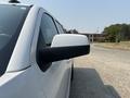 Side view of a white 2017 Chevrolet Silverado 1500 showcasing the side mirror and part of the vehicle's door