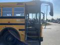 A 2006 Thomas Saf-T-Liner HDX school bus with an open door and steps leading inside