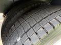 Close-up of the tire tread on a 1996 Kenworth T800 showing deep grooves and wear patterns indicating usage and age of the tire