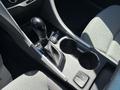 The interior of a 2015 Hyundai Sonata showing the gear shift lever center console and cup holders