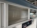 Interior of a 2020 Mercedes-Benz Sprinter 2500 featuring a sleek design with cabinet space and control panel elements