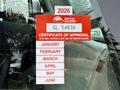 A 2016 International 7600 with a red British Columbia certificate of approval sticker displaying various months and the year 2026