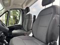 Interior view of a 2023 RAM Promaster 3500 highlighting two gray fabric seats with ergonomic design and adjustable headrests
