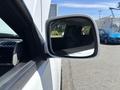 A side mirror of a 2011 Chevrolet Colorado showing a sleek design and clear reflection of the vehicle's interior