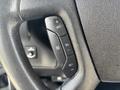 Close-up of the steering wheel controls of a 2020 Chevrolet Express including buttons for setting cruise control and adjusting speed