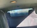 Interior view of a 2014 International 7400 showing the back seat area with a clear back window and a dark fabric seat