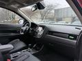 Interior of a 2016 Mitsubishi Outlander featuring black leather seats a central control console and a dashboard with navigation and display screens