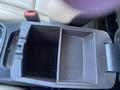 An empty center console storage compartment of a 2018 Hyundai Santa Fe with two divided sections