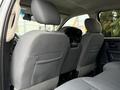 Interior view of a 2013 RAM 3500 featuring two gray cloth seats in the front row with headrests and a spacious cabin design