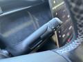 Close-up of the gear shift lever in a 2023 Fisker Ocean featuring a sleek design with options for reversing neutral and parking