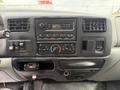 Interior dashboard of a 2004 Ford F-750 featuring a radio control panel with knobs and buttons for audio settings and air conditioning controls
