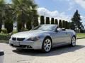 A silver 2004 BMW 6-Series convertible parked with its top down showcasing sleek lines and alloy wheels