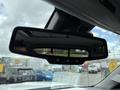 A rearview mirror from a 2017 Chevrolet Silverado 1500 showing buttons for settings and a sleek black design