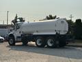 A 2016 Freightliner M2 106 truck with a white cylindrical tank mounted on the chassis and dual rear wheels