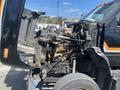 A 1996 GMC Top Kick with its hood open revealing the engine compartment and various mechanical components