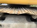 Close-up of the undercarriage of a 2018 John Deere 350 showing rusted metal tracks and rollers designed for heavy machinery movement