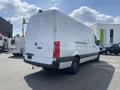 A white 2024 Mercedes-Benz Sprinter van viewed from the rear showing its sleek design and logo