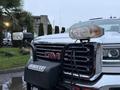 A 2017 GMC Sierra 3500HD truck with a black grill guard and mounted lights on the front