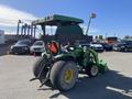 A green 2008 John Deere 3320 tractor with a 300X loader attachment and large rear tires parked in a lot