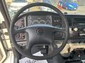 The interior view of a 2010 Freightliner M2 106 showing the steering wheel dashboard gauges and various control buttons