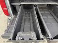A black storage compartment mounted in the bed of a 2018 Chevrolet Colorado with a sliding mechanism for easy access