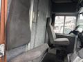 Interior of a 2012 Ford Econoline showing driver seat and passenger seat with gray upholstery