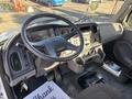Interior view of a 2005 Freightliner M2 106 showing the steering wheel dashboard and controls