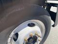 Close-up of a tire and wheel assembly from a 2014 International TerraStar displaying the rim bolts and some wear on the tire surface