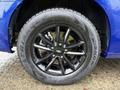 A close-up view of a black alloy wheel and tire of a 2020 Dodge Grand Caravan
