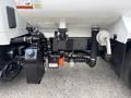 2025 Peterbilt 536 featuring various pipes valves and tanks connected to the chassis with visible components for fluid management and engine compatibility