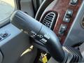 A control stalk featuring buttons for turn signals, headlights, and various vehicle functions in a Freightliner M2 106 truck