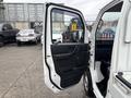 A 2010 Suzuki Carry with the driver's side door open showing the interior and dashboard details
