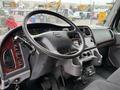The interior of a 2018 Freightliner M2 106 featuring a steering wheel dashboard controls and leather accents