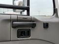 A close-up view of the door handle and window controls inside a 2009 UD Trucks UD 3300 cab